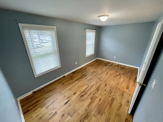 1895 Reservoir Ave, Bridgeport, CT 06606 - unfurnished bedroom with wood finished floors, baseboards, and visible vents