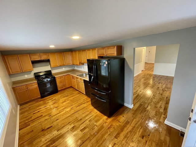 1895 Reservoir Ave, Bridgeport, CT 06606 - kitchen featuring light countertops, light wood finished floors, baseboards, and black appliances