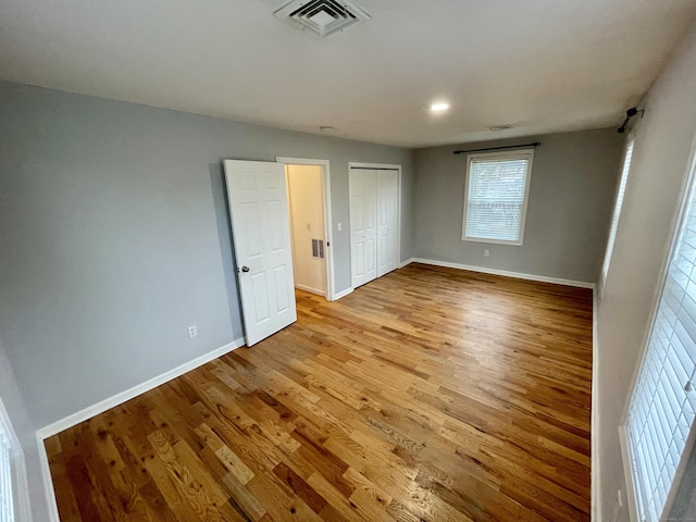 1895 Reservoir Ave, Bridgeport, CT 06606 - unfurnished bedroom featuring visible vents, baseboards, a closet, light wood-style floors, and recessed lighting
