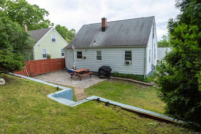 70 Manners Ave, Naugatuck, CT 06770 - back of property with a patio, a chimney, a shingled roof, and cooling unit
