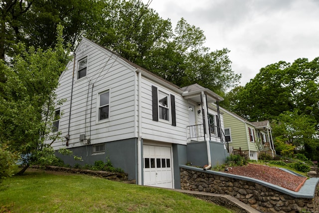 70 Manners Ave, Naugatuck, CT 06770 - view of side of home with an attached garage and a lawn