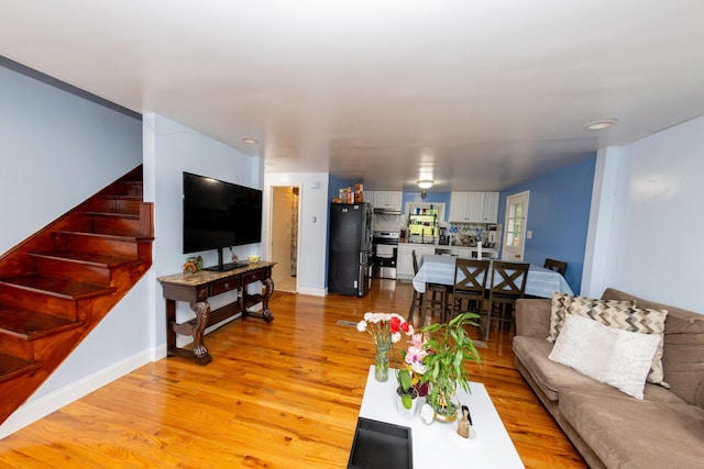 70 Manners Ave, Naugatuck, CT 06770 - living area with light wood-style floors and stairs