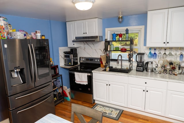 70 Manners Ave, Naugatuck, CT 06770 - kitchen with stainless steel appliances, decorative backsplash, light countertops, light wood-style flooring, and white cabinetry