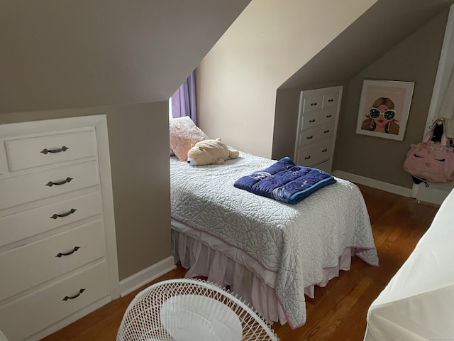 bedroom featuring baseboards and wood finished floors
