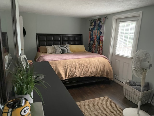 bedroom featuring a textured ceiling and wood finished floors