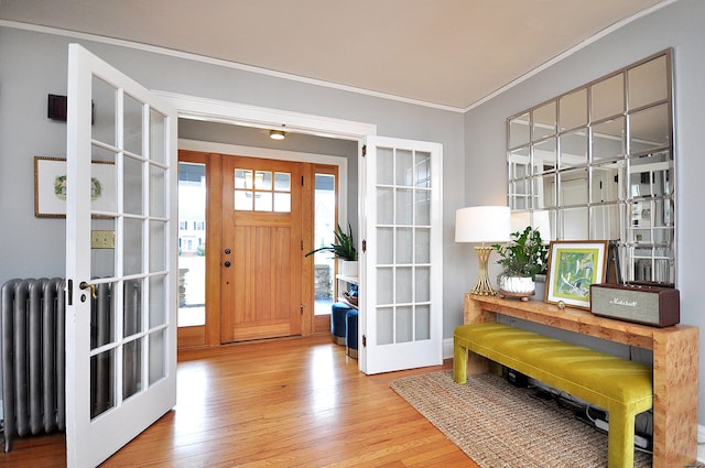 1186 Farmington Ave, West Hartford, CT 06107 - entrance foyer with ornamental molding, radiator, wood finished floors, and french doors
