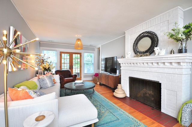 1186 Farmington Ave, West Hartford, CT 06107 - living area with crown molding, wood finished floors, a fireplace, and french doors