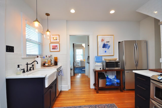 1186 Farmington Ave, West Hartford, CT 06107 - kitchen with stainless steel appliances, a sink, plenty of natural light, light wood-style floors, and recessed lighting