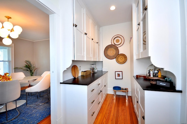 1186 Farmington Ave, West Hartford, CT 06107 - kitchen featuring dark countertops, white cabinetry, a chandelier, light wood-style floors, and recessed lighting