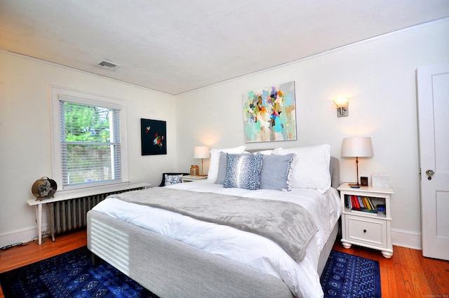 1186 Farmington Ave, West Hartford, CT 06107 - bedroom with radiator heating unit, wood finished floors, and baseboards