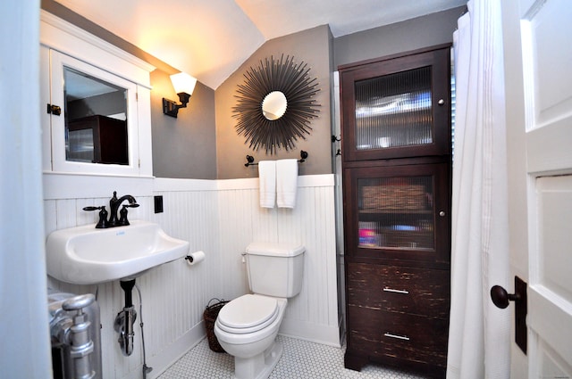 1186 Farmington Ave, West Hartford, CT 06107 - half bath featuring toilet, wainscoting, and vaulted ceiling