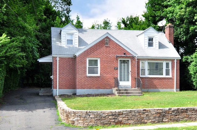27 Brook St, New Britain, CT 06051 - new england style home with brick siding, a chimney, entry steps, driveway, and a front lawn