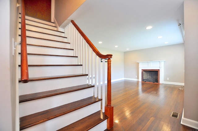 27 Brook St, New Britain, CT 06051 - stairway featuring wood finished floors, recessed lighting, and a brick fireplace