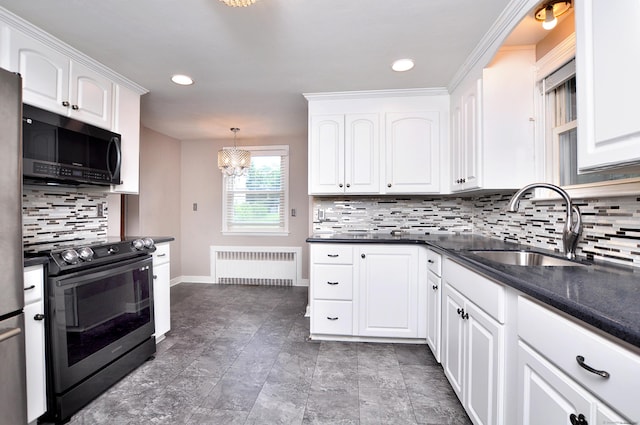 27 Brook St, New Britain, CT 06051 - kitchen with radiator, appliances with stainless steel finishes, white cabinetry, decorative backsplash, and a chandelier