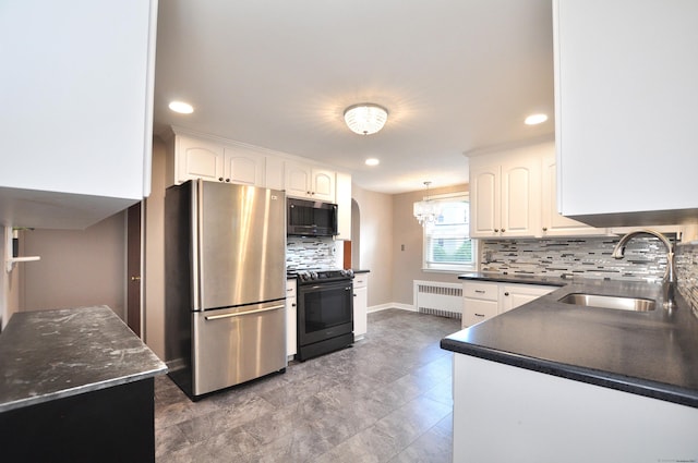 27 Brook St, New Britain, CT 06051 - kitchen with appliances with stainless steel finishes, radiator, white cabinetry, backsplash, and recessed lighting