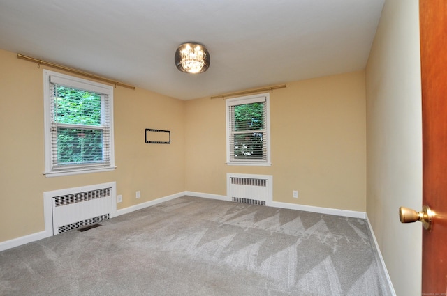 27 Brook St, New Britain, CT 06051 - spare room featuring radiator heating unit and carpet flooring