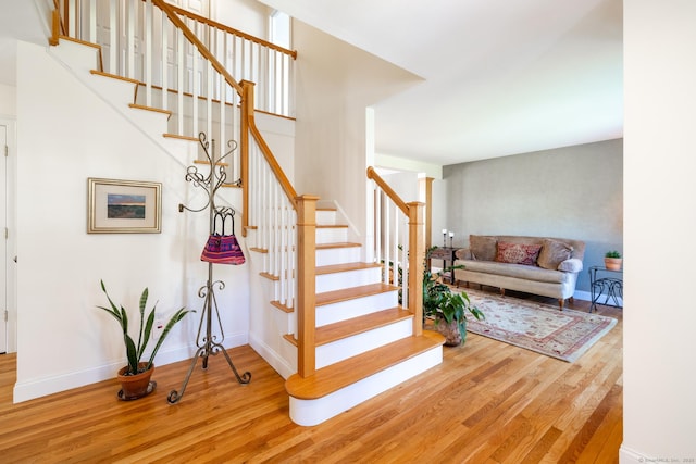 stairs with baseboards and wood finished floors