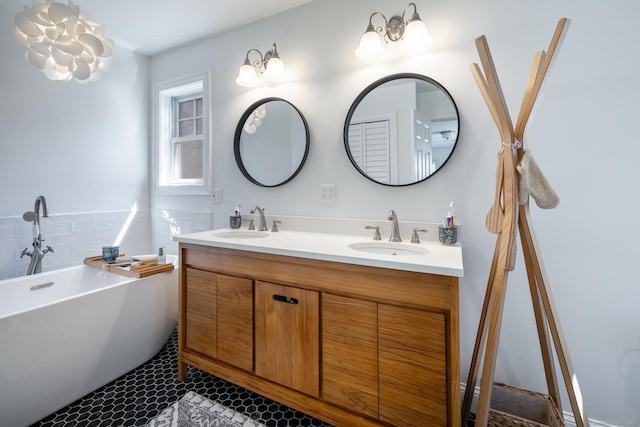 bathroom featuring a soaking tub, a sink, tile patterned flooring, and double vanity
