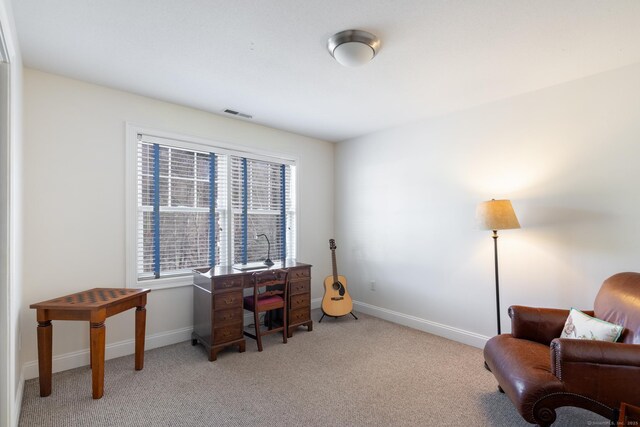 office space featuring light carpet, a healthy amount of sunlight, and baseboards