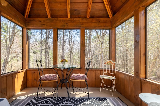 sunroom / solarium featuring beamed ceiling