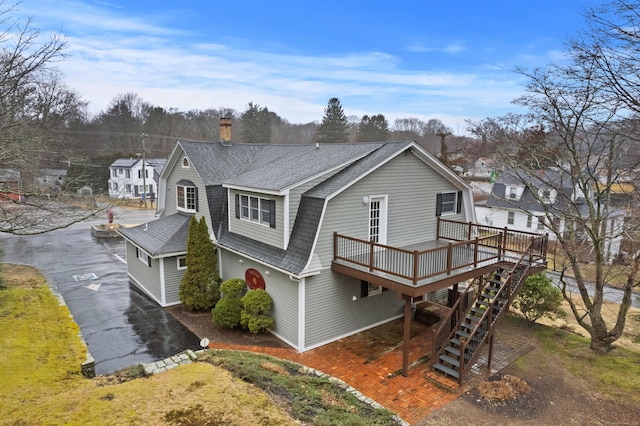 197 Norwich New London Tpke, Montville, CT 06382 - back of property with a shingled roof, a chimney, stairway, a wooden deck, and a gambrel roof