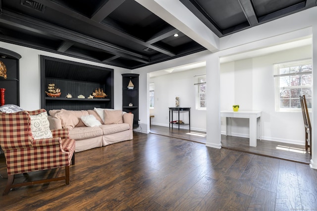 living room with visible vents, plenty of natural light, coffered ceiling, and wood-type flooring