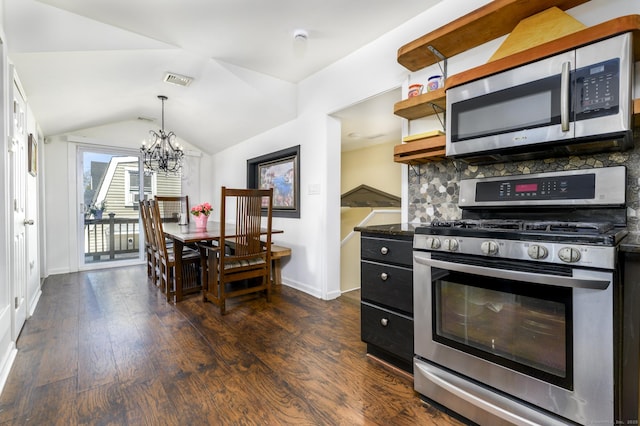 kitchen featuring a notable chandelier, dark wood-style flooring, stainless steel appliances, and baseboards