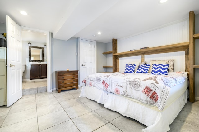 bedroom with recessed lighting, light tile patterned flooring, and ensuite bathroom