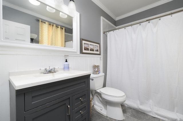 full bathroom with tile patterned flooring, a wainscoted wall, toilet, vanity, and crown molding