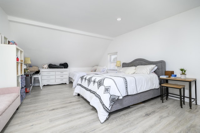 bedroom with recessed lighting, vaulted ceiling, and wood finished floors