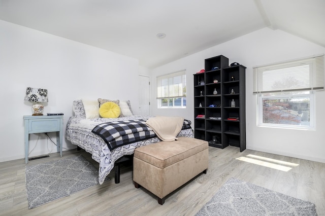 bedroom featuring lofted ceiling and wood finished floors