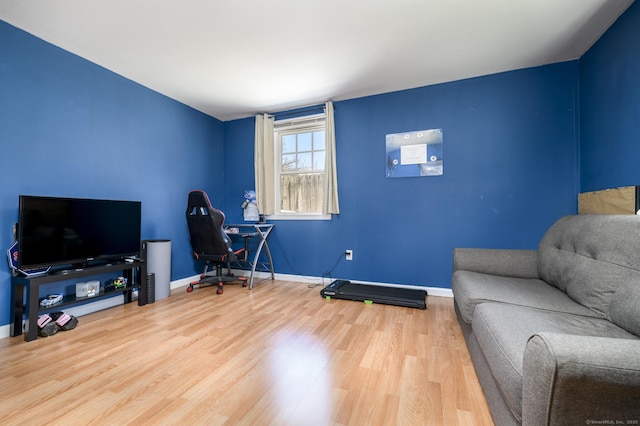 interior space with wood finished floors and baseboards