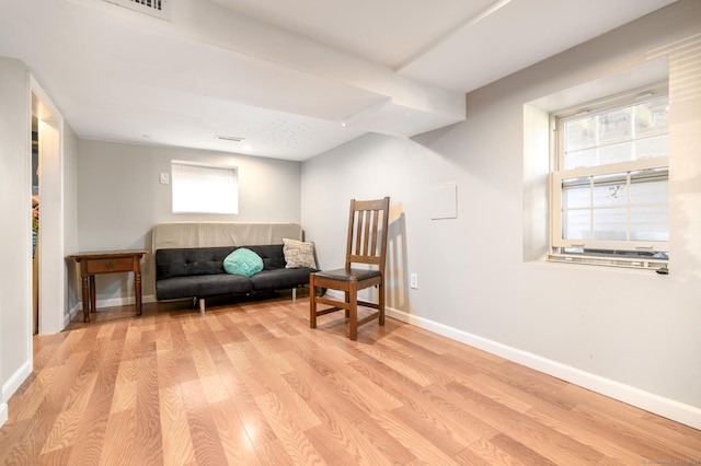 sitting room with light wood-style floors and baseboards
