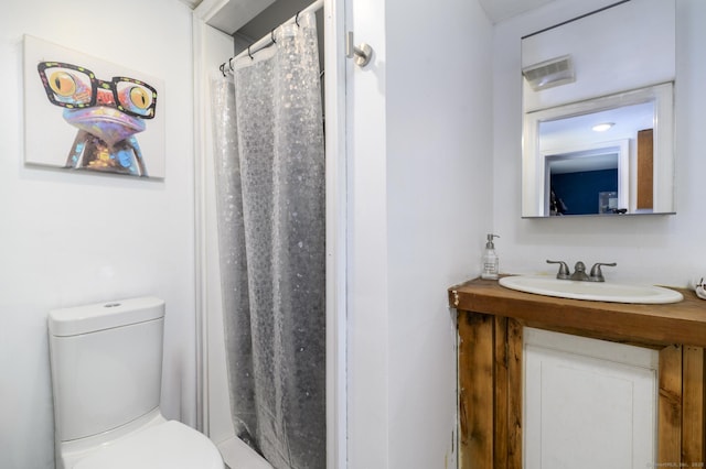 bathroom featuring visible vents, toilet, and vanity