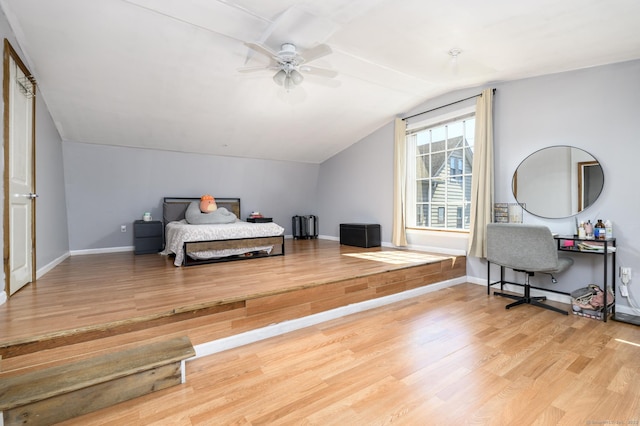 bedroom featuring lofted ceiling, wood finished floors, ceiling fan, and baseboards