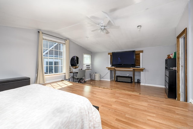 bedroom with ceiling fan, cooling unit, vaulted ceiling, baseboards, and wood finished floors