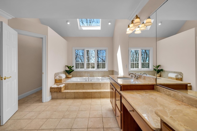 710 Alexander Dr, Guilford, CT 06437 - bathroom featuring lofted ceiling with skylight, a garden tub, tile patterned flooring, and vanity