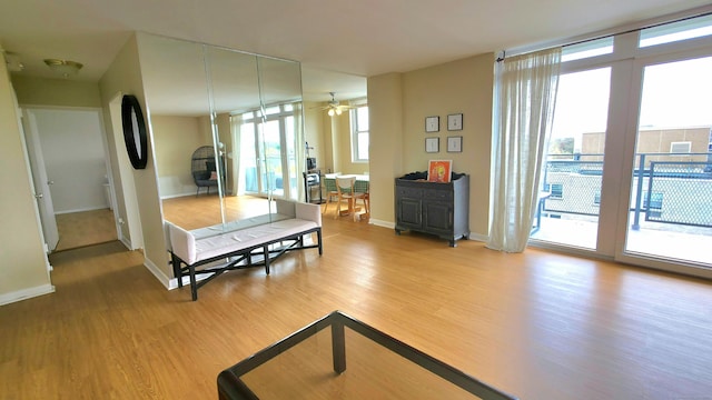 bedroom featuring baseboards, wood finished floors, and access to outside