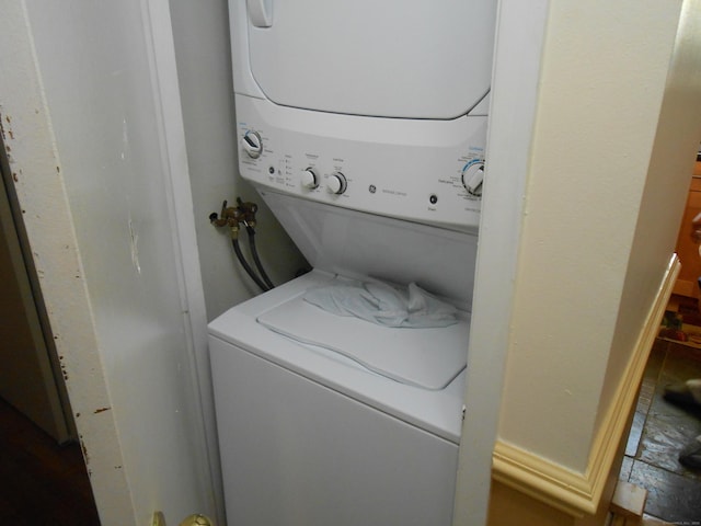 clothes washing area with laundry area and stacked washer / drying machine