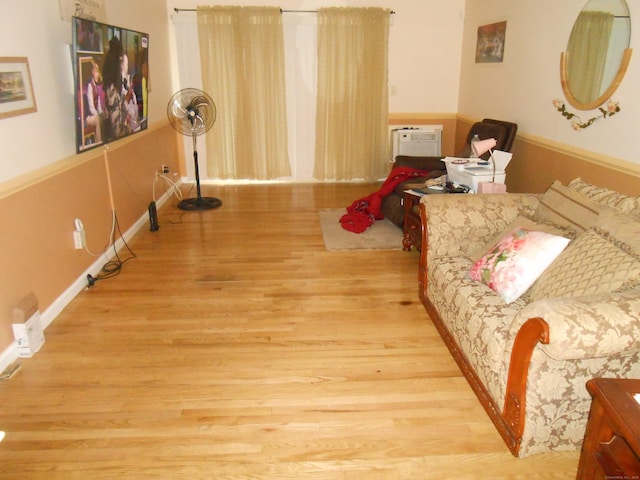 interior space featuring baseboards and wood finished floors