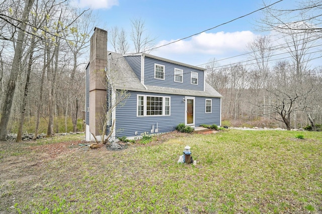 378 Rte 87, Columbia, CT 06237 - view of front of home featuring a chimney, a shingled roof, and a front lawn