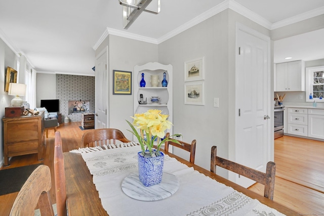 378 Rte 87, Columbia, CT 06237 - dining space with a fireplace, crown molding, and light wood-type flooring