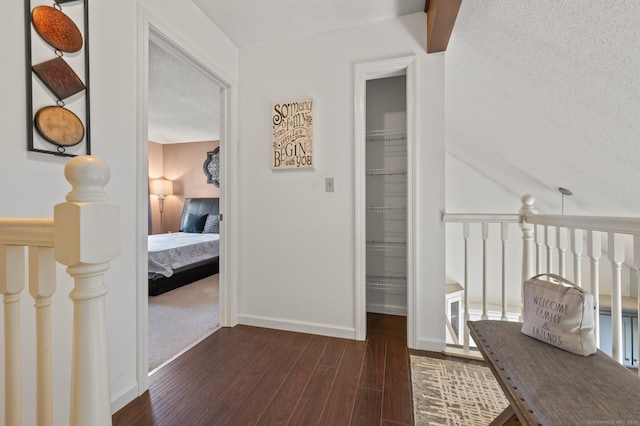 1 Abbott Rd Unit 32, Ellington, CT 06029 - corridor with dark wood-type flooring, a textured ceiling, and baseboards