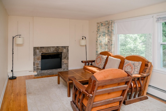 6 Eastwood Rd, Mansfield, CT 06268 - living room with a fireplace, wood finished floors, and a baseboard radiator
