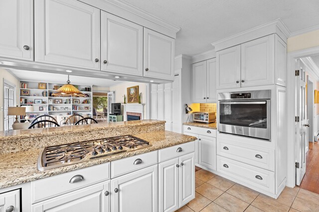 9 Academy Ln, Old Lyme, CT 06371 - kitchen with stainless steel appliances, white cabinets, and light tile patterned flooring