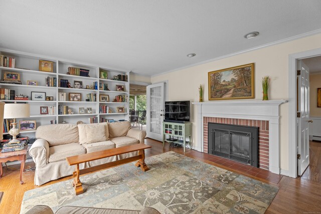 9 Academy Ln, Old Lyme, CT 06371 - living room with ornamental molding, wood finished floors, a fireplace, and a baseboard radiator
