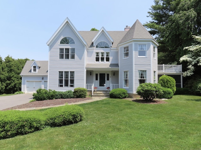 9 Academy Ln, Old Lyme, CT 06371 - view of front of property with a front yard, an attached garage, concrete driveway, and a chimney