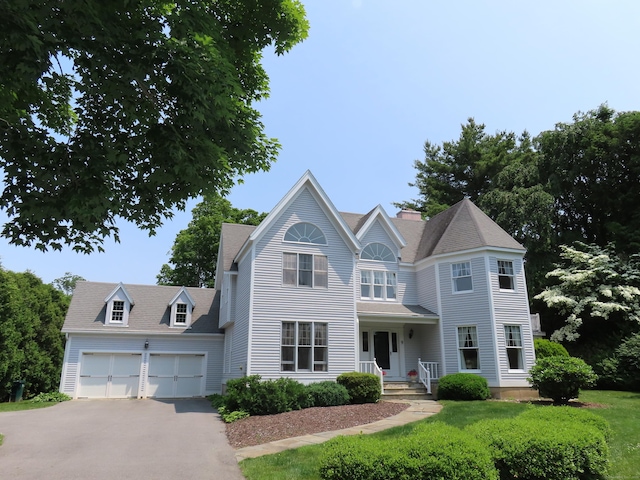 9 Academy Ln, Old Lyme, CT 06371 - view of front of home with a garage, driveway, and a front lawn