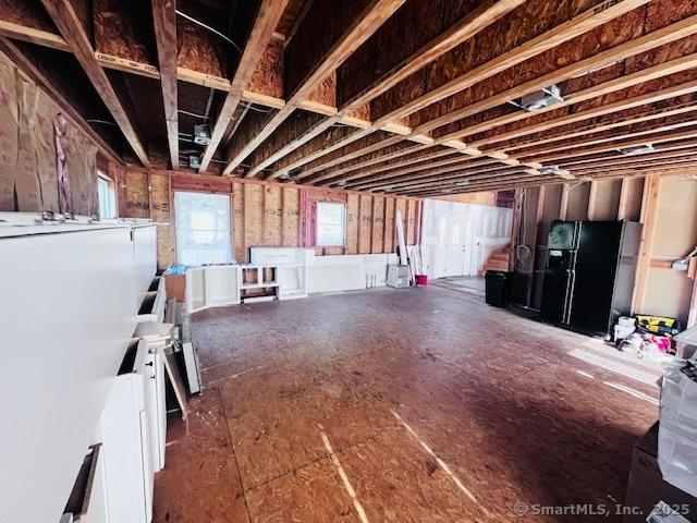 37 Fulton Dr, New Fairfield, CT 06812 - below grade area featuring black fridge with ice dispenser