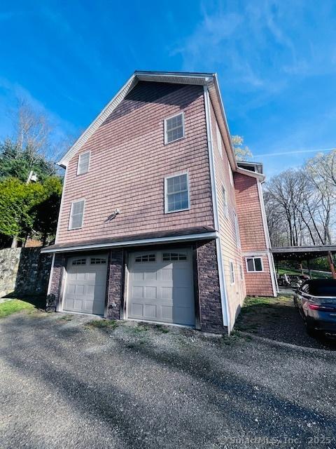 37 Fulton Dr, New Fairfield, CT 06812 - view of home's exterior with an attached garage and driveway
